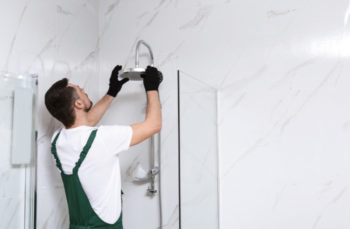 Handwerker in fugenloser Dusche